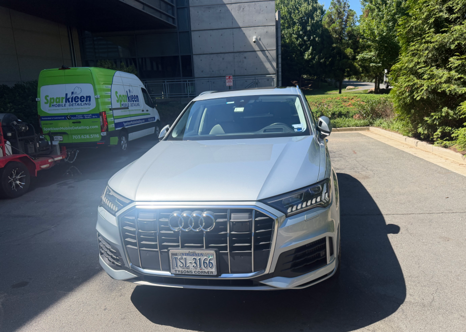 Silver Audi SUV parked outside building