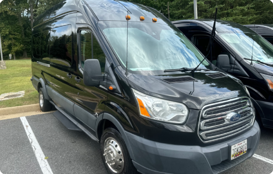 Black Ford Transit passenger van in parking lot